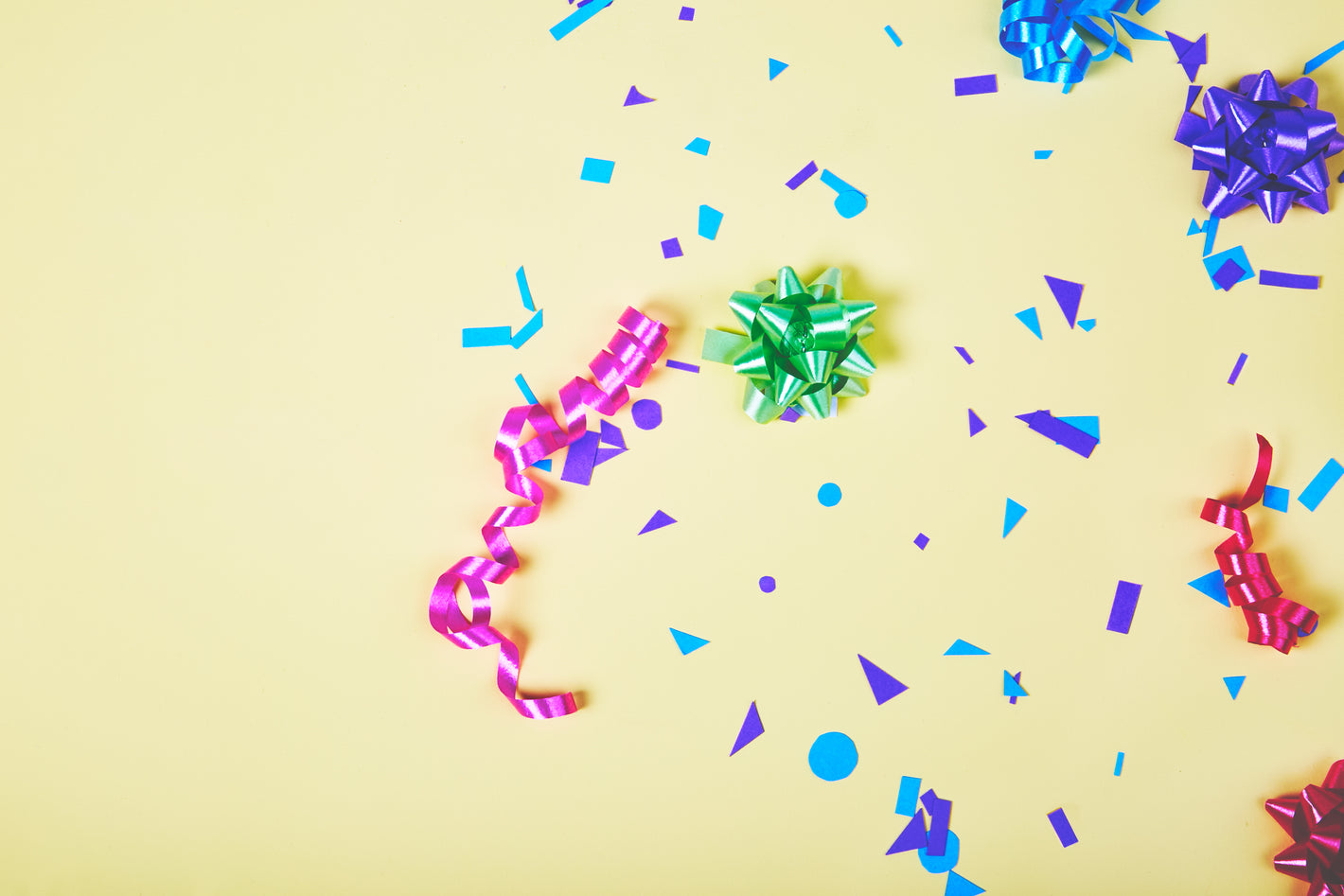 Birthday party gift trimmings with colorful confetti and bows.