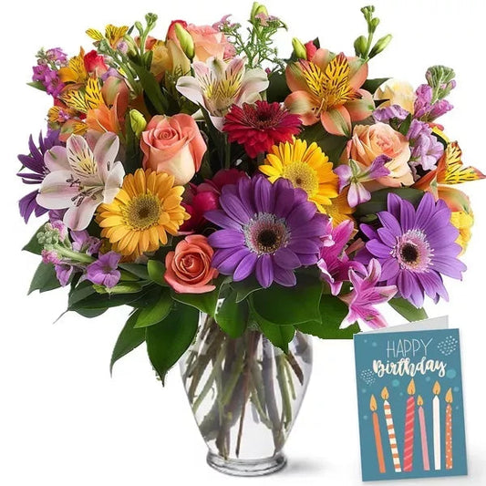 A vibrant bouquet of mixed flowers in a vase with a 'Happy Birthday' card.