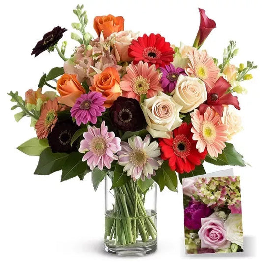 A vibrant bouquet of mixed flowers including roses and gerberas in a glass vase, with a small inset of pink roses.