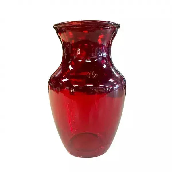 A red glass vase on a white background.