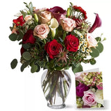 A variety of roses and flowers in a glass vase with a small image inset.
