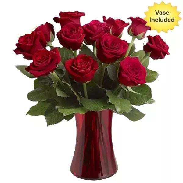 A bouquet of red roses in a red vase with a "Vase Included" label.