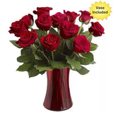 A bouquet of red roses in a red vase with a "Vase Included" label.