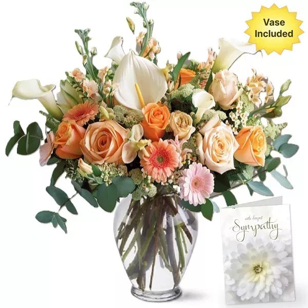 Bouquet of roses and lilies in a vase with a sympathy card.