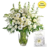 A large bouquet of white flowers in a vase with a sympathy card.