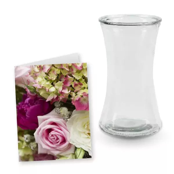 A flower card next to an empty, clear glass vase.